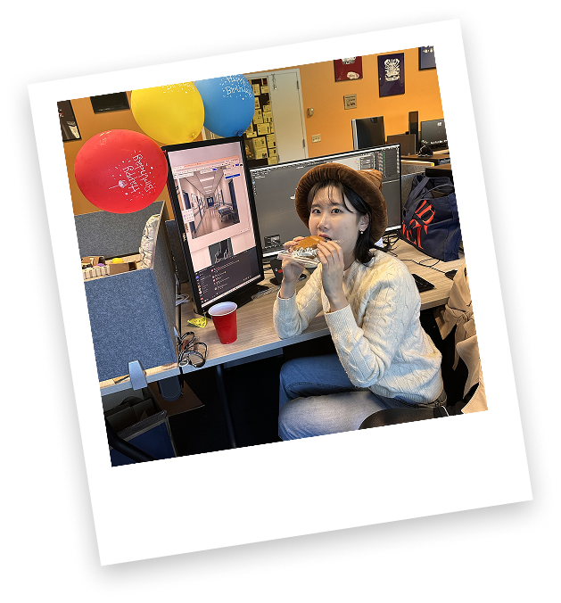 Jiwon at her desk with birthday balloons.