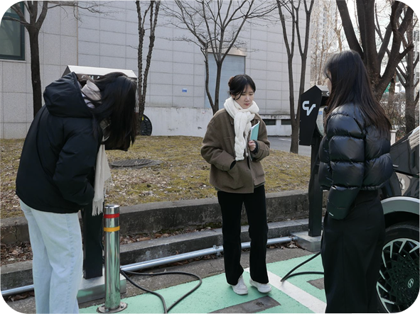 Team members filming a demo outdoors beside a Hyundai EV.